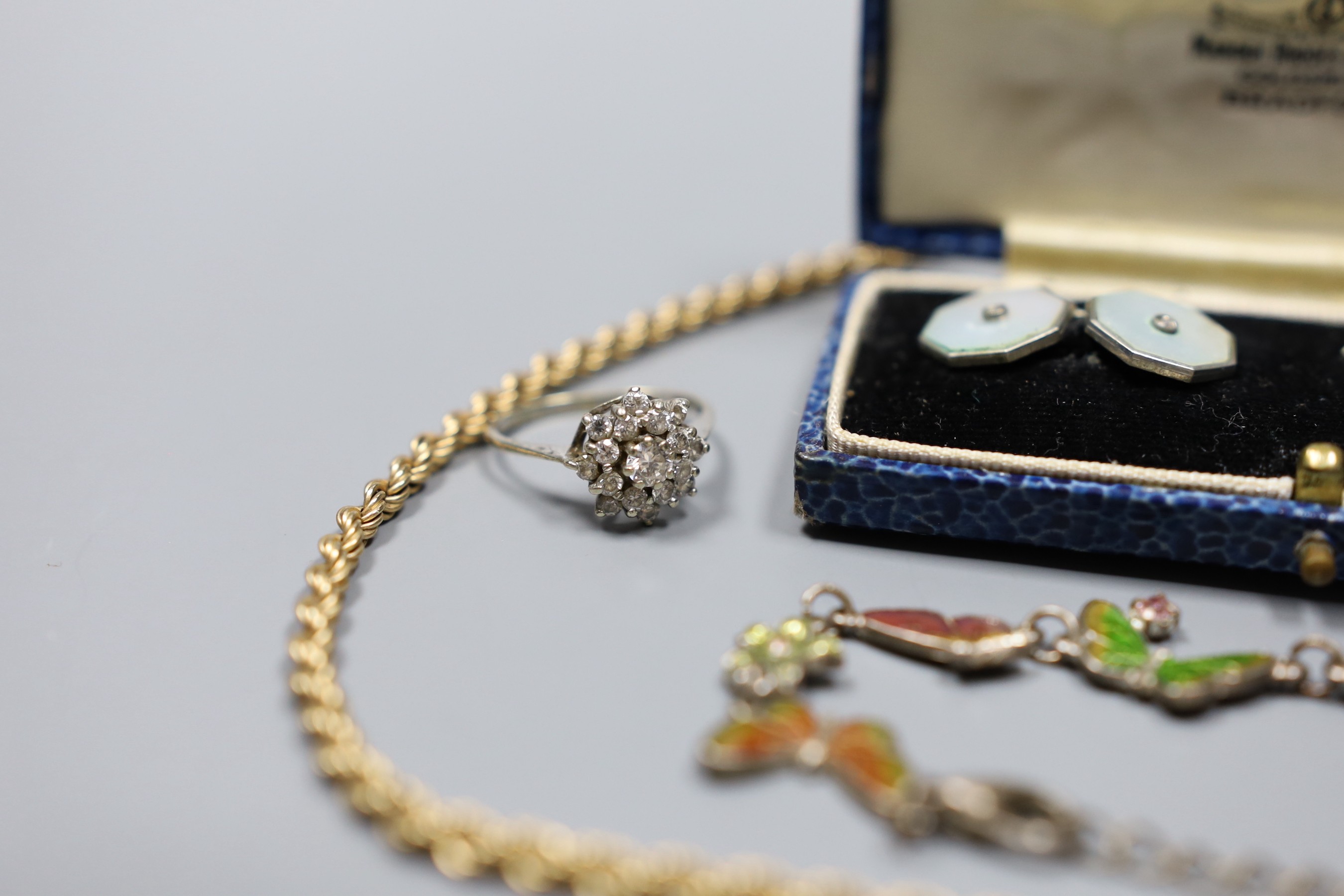 A modern 9ct gold rope twist chain, 5.2 grams, a white metal and enamel butterfly link bracelet, a pair of mother of pearl and base metal cufflinks in box, a gold plated cufflink and a silver dress ring.